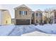 Brick two-story house with a brown garage door and snowy yard at 2959 Hearthside Dr, Greenwood, IN 46143
