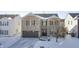 Brick two-story house with a brown garage door and snowy yard at 2959 Hearthside Dr, Greenwood, IN 46143