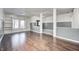 Spacious living room with hardwood floors, built-in shelves, and gray walls at 2959 Hearthside Dr, Greenwood, IN 46143