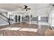 Open living room with hardwood floors, kitchen view, and a staircase at 2959 Hearthside Dr, Greenwood, IN 46143