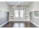 Living room with hardwood floors, built-in shelves, and a window seat at 2959 Hearthside Dr, Greenwood, IN 46143