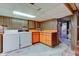 Unfinished basement laundry area with orange cabinets at 4522 Thornleigh Dr, Indianapolis, IN 46226
