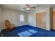 Bedroom with blue carpet, ceiling fan, and rocking chair at 4522 Thornleigh Dr, Indianapolis, IN 46226