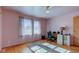 Home office in bedroom with hardwood floors, ceiling fan, and window at 4522 Thornleigh Dr, Indianapolis, IN 46226