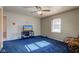 Bedroom with blue carpet, TV stand, ceiling fan and rocking chair at 4522 Thornleigh Dr, Indianapolis, IN 46226