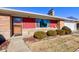 Neat front entrance with a red accented facade and landscaping at 4522 Thornleigh Dr, Indianapolis, IN 46226