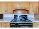 Detailed view of a kitchen featuring wood cabinets and a black stove at 4522 Thornleigh Dr, Indianapolis, IN 46226