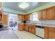 Bright kitchen featuring wood cabinets, ample counter space, and a view to the dining area at 4522 Thornleigh Dr, Indianapolis, IN 46226