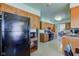 Open concept kitchen with black refrigerator and wood cabinets at 4522 Thornleigh Dr, Indianapolis, IN 46226