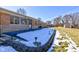 Back patio with snow and landscape lighting at 4522 Thornleigh Dr, Indianapolis, IN 46226