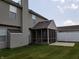 Backyard featuring a screened-in porch and concrete patio, perfect for outdoor entertaining and relaxation at 6442 E Flat Rock Dr, Camby, IN 46113