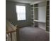 Upstairs bonus room with built-in shelving and ample light, offering a versatile space for work or leisure at 6442 E Flat Rock Dr, Camby, IN 46113