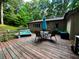 Backyard deck with outdoor furniture, a turquoise umbrella, and a hot tub for relaxation at 797 S Graveyard Rd, Paragon, IN 46166