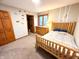 Cozy bedroom featuring a wooden bed frame, closet, and decor, enhancing the rustic atmosphere at 797 S Graveyard Rd, Paragon, IN 46166