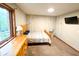 Bedroom with rustic decor, a bed with wooden frame, and a large window with outdoor view at 797 S Graveyard Rd, Paragon, IN 46166
