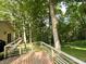 Wide wooden deck surrounded by trees for privacy and enjoying the outdoors at 797 S Graveyard Rd, Paragon, IN 46166