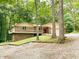 Charming brick home with a spacious balcony, a red door, and a gravel driveway at 797 S Graveyard Rd, Paragon, IN 46166