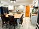Open kitchen with a large dining table, updated appliances, and gray and white cabinets at 797 S Graveyard Rd, Paragon, IN 46166