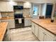 Updated kitchen features stainless steel appliances, butcher block countertops, and a breakfast bar at 797 S Graveyard Rd, Paragon, IN 46166