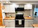 Updated kitchen featuring light-colored cabinets, wood countertops, and modern black appliances at 797 S Graveyard Rd, Paragon, IN 46166