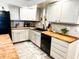 Bright kitchen features butcher block countertops, a mosaic backsplash, and ample cabinet space at 797 S Graveyard Rd, Paragon, IN 46166