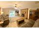 Cozy living room featuring a brick fireplace, ceiling fan, sliding glass door, and comfortable seating at 797 S Graveyard Rd, Paragon, IN 46166