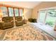 Living room with large windows, a glass sliding door, and two reclining chairs at 797 S Graveyard Rd, Paragon, IN 46166