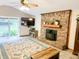 Bright living room showcasing a brick fireplace, ceiling fan, and sliding glass door to the backyard at 797 S Graveyard Rd, Paragon, IN 46166