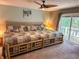 Spacious main bedroom with a decorative ceiling fan, large bed, and balcony access at 797 S Graveyard Rd, Paragon, IN 46166