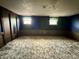 Finished basement with paneled walls, carpet flooring, and natural light at 801 Spring Valley Dr, Indianapolis, IN 46231