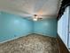 Bright bedroom featuring blue walls, a ceiling fan, and natural light streaming through the window at 801 Spring Valley Dr, Indianapolis, IN 46231
