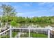 Balcony view of a tranquil river surrounded by lush trees at 2222 E 75Th St, Indianapolis, IN 46240