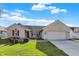 Ranch style home with 2-car attached garage and manicured lawn at 7711 Blue Willow Dr, Indianapolis, IN 46239