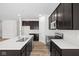 Modern kitchen with dark cabinets, white countertops, and a large island at 10109 Redwood Peak Ln, Indianapolis, IN 46259