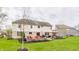 Spacious backyard with a patio area, complete with seating and an umbrella, perfect for relaxation at 10866 Flower Mound Pl, Fishers, IN 46037