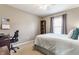 Comfortable bedroom with a desk, a bed, and a window offering ample light at 10866 Flower Mound Pl, Fishers, IN 46037