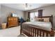 Inviting bedroom features a cozy bed, wood furniture, and natural light, creating a warm atmosphere at 10866 Flower Mound Pl, Fishers, IN 46037
