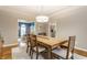 Well-lit dining area with a wooden table, six chairs, and an open view to other rooms at 10866 Flower Mound Pl, Fishers, IN 46037