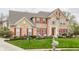Beautiful brick home with red shutters and a manicured lawn, showcasing suburban living at 10866 Flower Mound Pl, Fishers, IN 46037