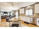 Open concept kitchen with white cabinets, granite countertops, and seamless flow to the living area at 10866 Flower Mound Pl, Fishers, IN 46037