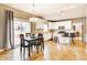 Bright kitchen with hardwood floors, a dining area, and sliding doors leading to the patio at 10866 Flower Mound Pl, Fishers, IN 46037