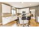 Well-lit kitchen featuring white cabinets, granite countertops, and stainless steel appliances at 10866 Flower Mound Pl, Fishers, IN 46037
