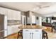 Bright kitchen features stainless steel appliances, ample cabinets, and a granite countertop island with seating at 10866 Flower Mound Pl, Fishers, IN 46037