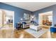 Open-concept living room showcasing hardwood floors, neutral decor, and seamless flow into other living spaces at 10866 Flower Mound Pl, Fishers, IN 46037