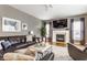 Cozy living room boasts a fireplace, large TV, and comfortable seating, perfect for relaxation at 10866 Flower Mound Pl, Fishers, IN 46037