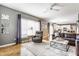 Inviting living room featuring hardwood floors, stylish decor, and a large window for ample natural light at 10866 Flower Mound Pl, Fishers, IN 46037