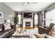 Relaxing living room features a fireplace, comfortable seating, and natural light, creating a warm atmosphere at 10866 Flower Mound Pl, Fishers, IN 46037