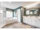 Luxurious main bathroom featuring a soaking tub, a glass shower, and double sink vanity with cabinetry at 10866 Flower Mound Pl, Fishers, IN 46037