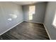 Simple bedroom with grey walls, wood-look floors, and a window at 1719 Nelson Ave, Indianapolis, IN 46203