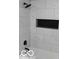 Modern bathroom with marble-look tile and black accents at 231 S Routiers Ave, Indianapolis, IN 46219